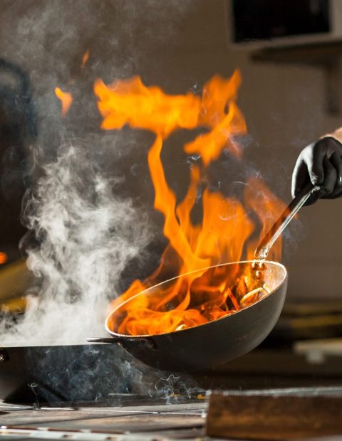 cook making dinner in the kitchen of high-end restaurant